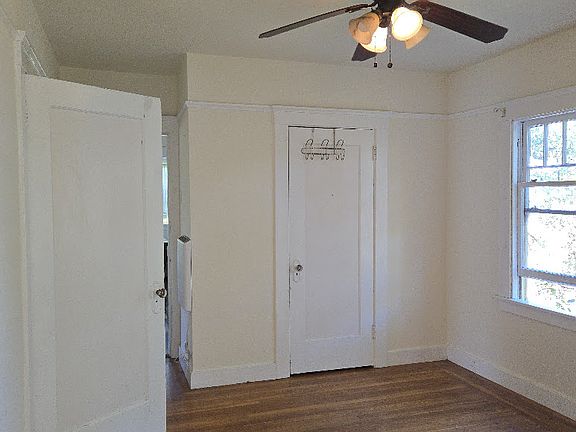View Of Bedroom From Bonus Room Entrance Way With Closed Closet Door And Windows Out To Back Garden Area To The Right