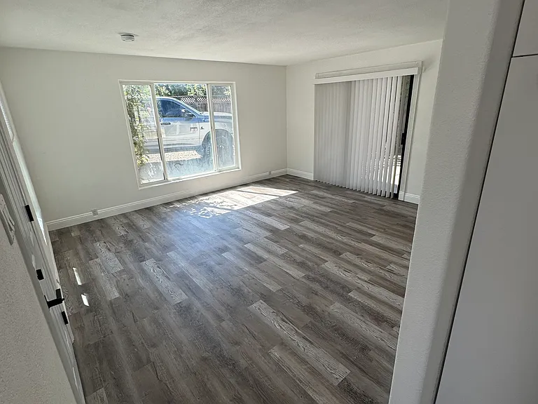 Living room view towards front window from kitchen.