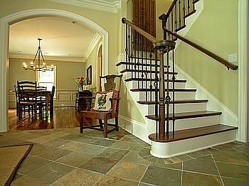 Large foyer with custom made mahogony doors, slate floors and arched doorways