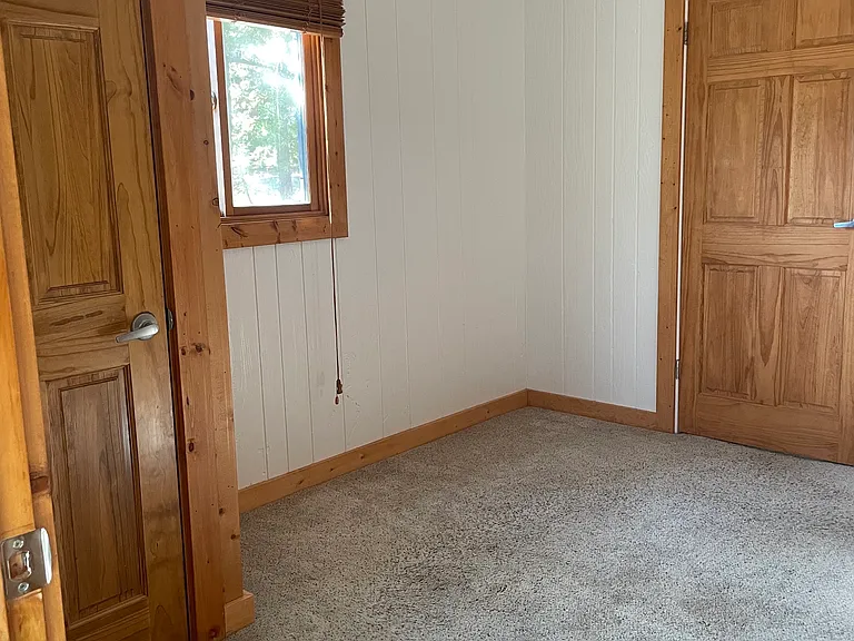 Main bedroom. We comfortably fit a queen bed, armoire and storage ottoman.