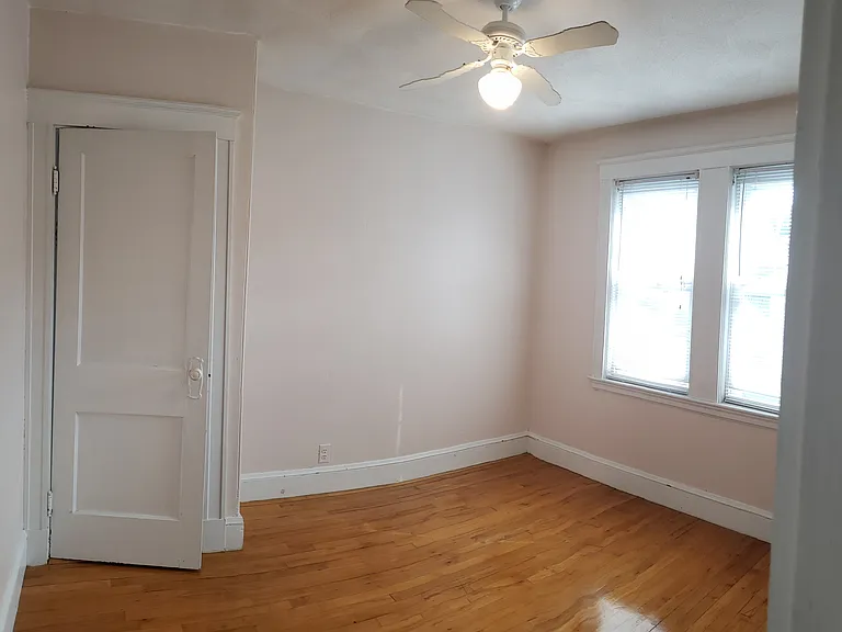 One of the bedrooms with ceiling fan and large windows for lots of natural light