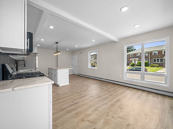 VIEW OF LIVING ROOM AND KITCHEN-OPEN SPACE WITH LARGE WINDOWS