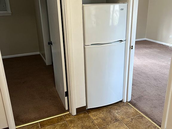 kitchen showing refrigerator/freezer with built-in storage above