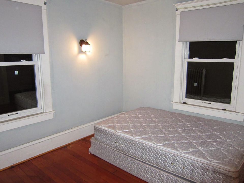 Bedroom with 2 windows and hardwood floors