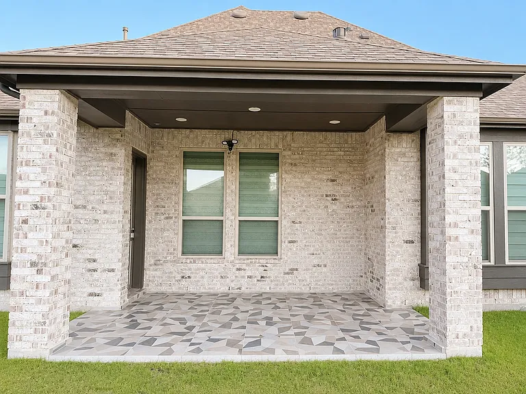 Extended Patio in backyard with Tile flooring