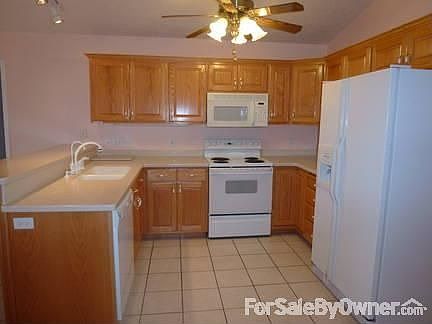 Front view
						:
						View showing the front. The master bedroom window is behind the pine tree.