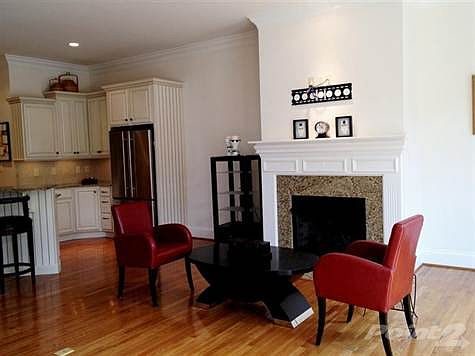 Gas fireplace with traditional mantel and granite surround. AV wiring throughout home was installed by Barney Miller's.