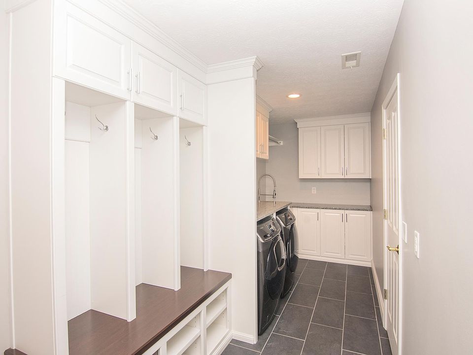 Custom locker cabinets with tile floors on entry from garage.