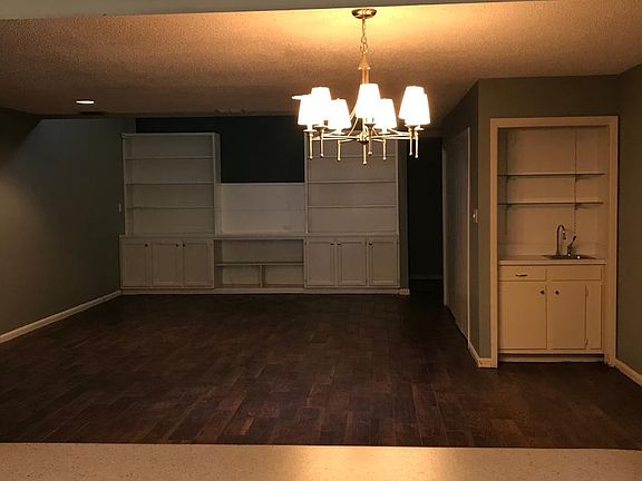 Kitchen overlooks open dining and living floor plan with wet