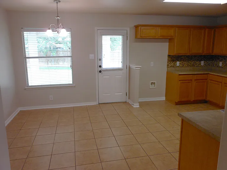 Breakfast nook and entry to spacious backyard and overed patio.