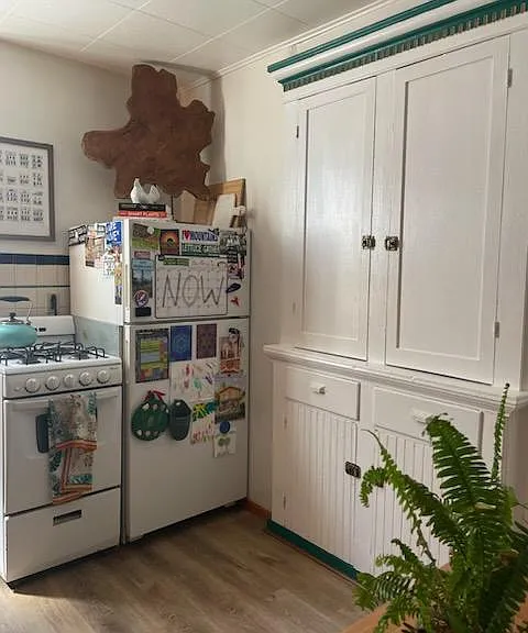 Newer photo showing new flooring. Kitchen with built-in cabinetry.