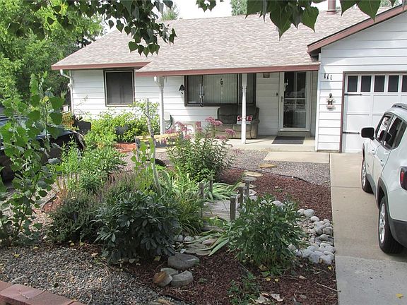 Beautiful landscaped front yard, mature trees, extra long dr
