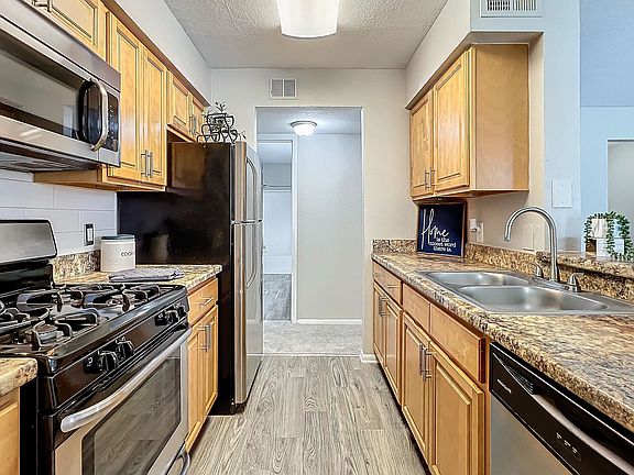 Experience the joy of cooking in our modern gourmet kitchen, featuring stainless steel appliances, granite-style countertops, and ample cabinet space.