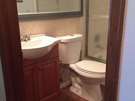Tidy hallway bathroom with tub and shower.