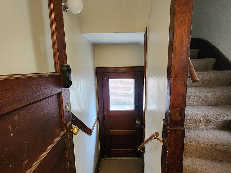 Kitchen back hall view to back door/stairs to basement.