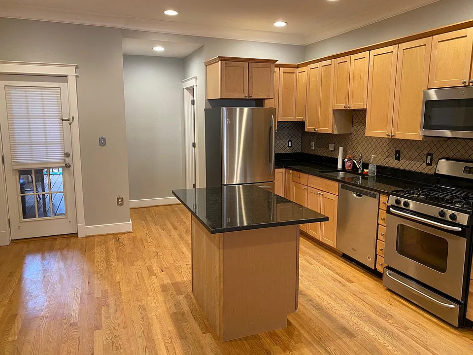 Kitchen, facing rear of property, 1/2 bathroom in back