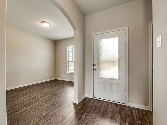 The foyer is highighted by a beautiful 3 4 lite front door
