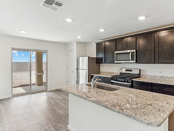 Upgraded kitchen with granite countertops and espresso cabinetry.