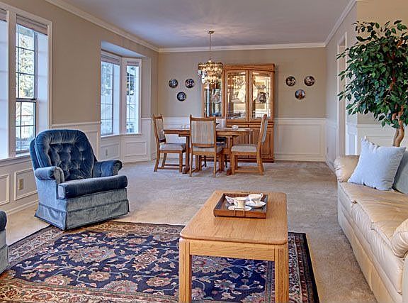 Spacious formal living and dining room are enhanced with shadow box wainscoting feature and crown mo
