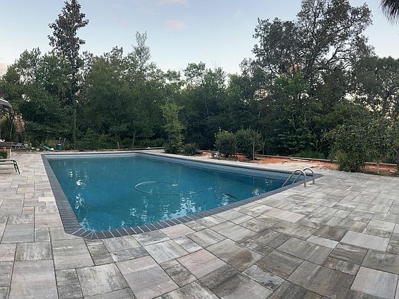BRAND NEW POOL AND DECK. Pool is 20x40 and 9 feet deep. Landscaping has since been completed