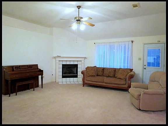 Large family room with gas log fireplace. Carpet less than 3 years old.