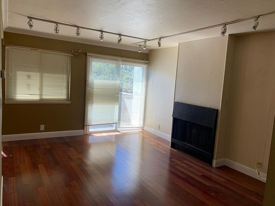 Living room. Windows are on west side. Shade is closed in pic.