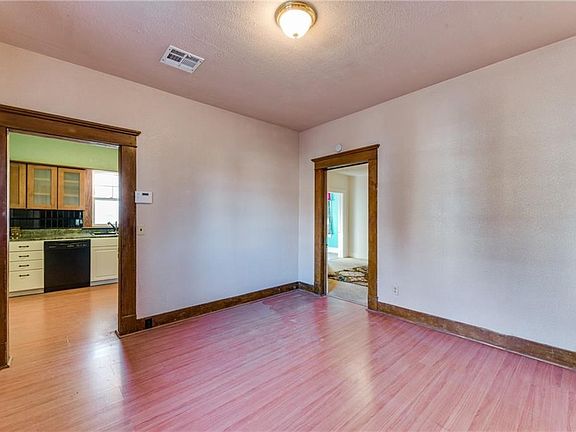 Formal dining with view into kitchen and master bedroom.