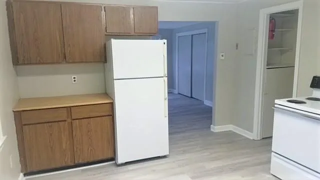 Lots of cabinets and full size refrigerator.