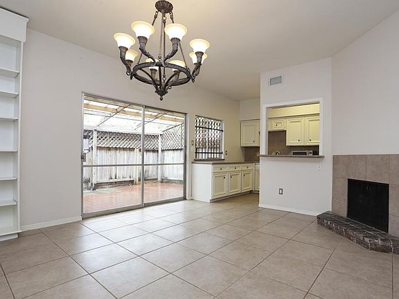 Cozy den off of living/dining combination with beautiful chandelier with wood burning fire place and