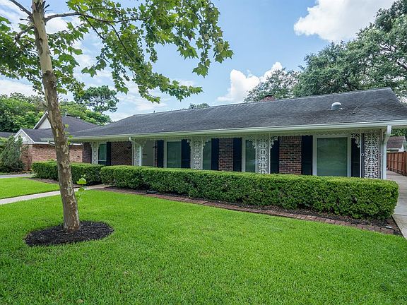A single wide driveway leads to a private stained fence and into a two car garage at the back of the home for added privacy! Mature trees & lush lawn offers great curb appeal!