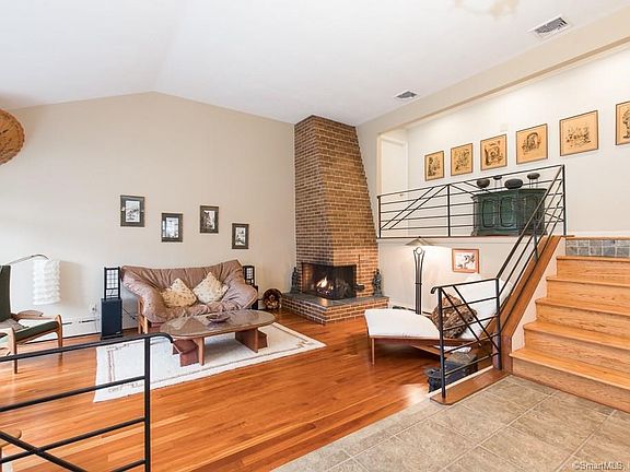 Living room with cherry hardwood floors, gas fireplace and vaulted ceiling