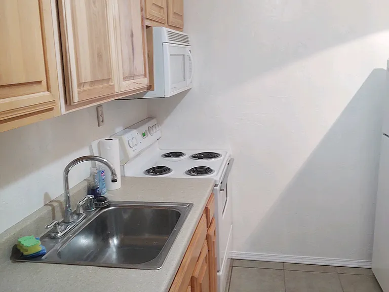 Lots of kitchen cabinets for storage.