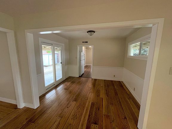 Formal dining room with wainscoating and sliding doors to private patio
