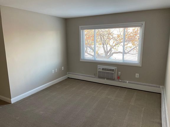 Living room with through-the-wall air conditioner unit.