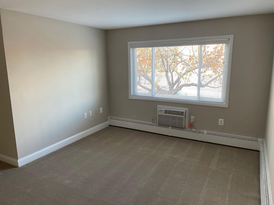 Living room with through-the-wall air conditioner unit.