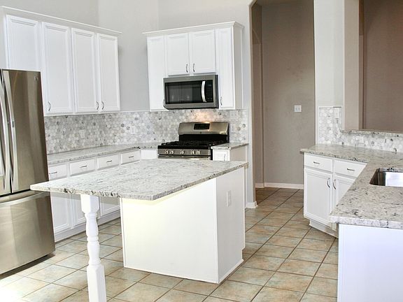 recently updated leathered granite, tile backsplash and paint in the kitchen