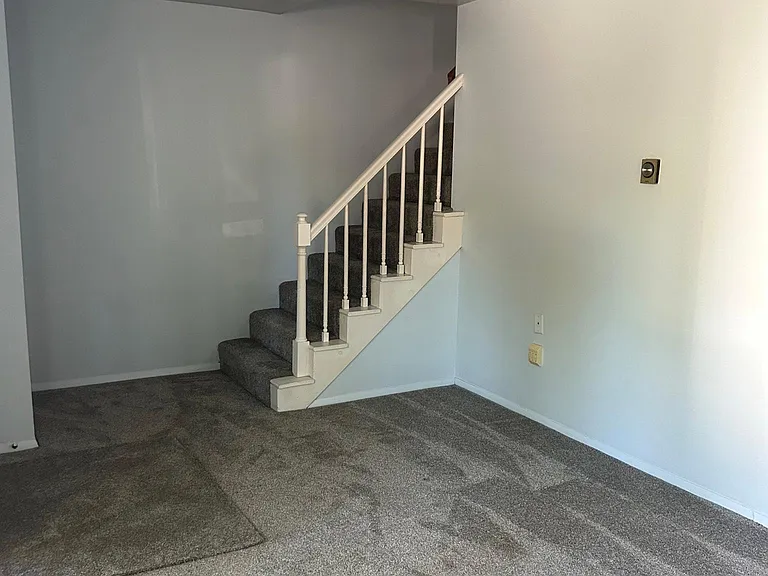 Living room with ceiling fan also has large closet for coats and additional storage.