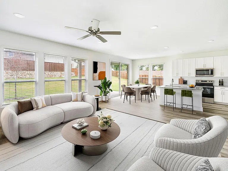 Expansive windows and open design fill this Amavi Celina detached home with natural light, leading to a spacious patio perfect for gatherings and quiet evenings alike.