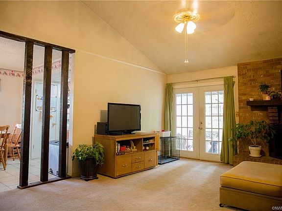 The open floor plan with high ceilings makes the family room feel bigger.  The French doors open to the back yard.