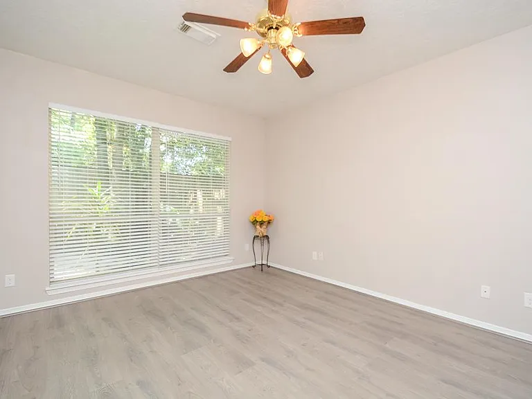 Master bedroom lots of natural light, wood floor