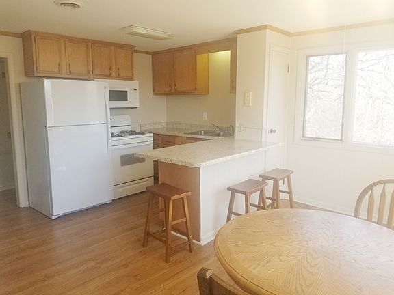 The kitchen also has a breakfast bar with stools