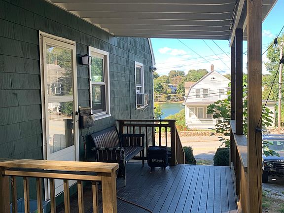 Covered porch off of kitchen with mill river views!