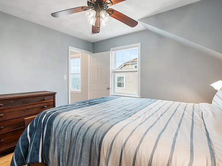 First bedroom with double bed and clothes storage