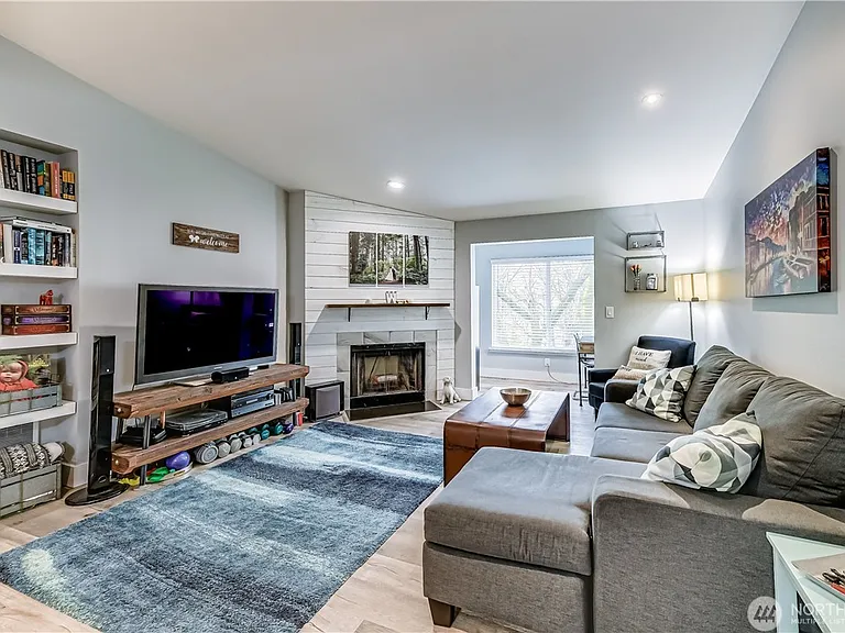 This open-room concept makes this top-floor, end-unit feel much bigger than it is. Even on the darkest day, this unit feels light, bright, and airy. Custom touches like shiplap and new ceramic tile around the fireplace.