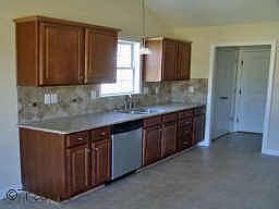 KITCHEN WITH GRANITE COUNTERTOPS & DECORATIVE TILE BACKSPLASH