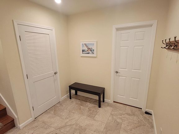 Entry and doors to laundry room, number one bedroom and two car garage