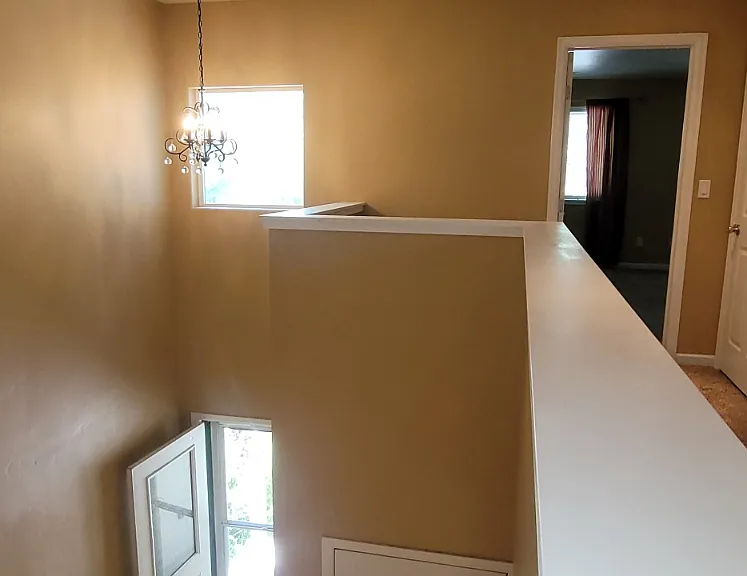Looking at the top of the stairs on 2nd level down to entry and back towards master bedroom.