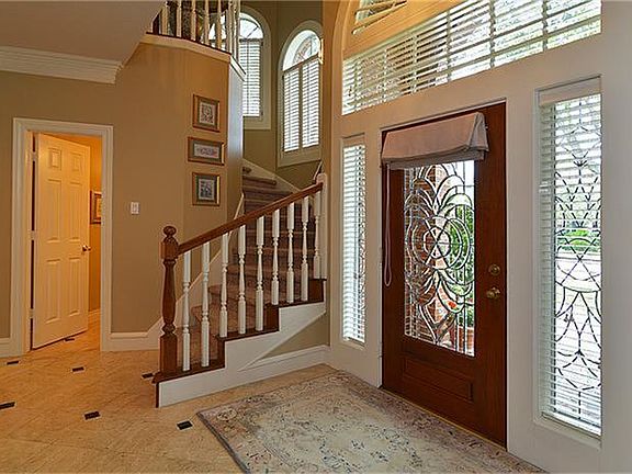 Two story marble entry w/granite inserts.Lead glass custom front door and transoms.