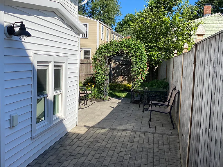 Right side entrance to back yard. New patio for upstairs unit.