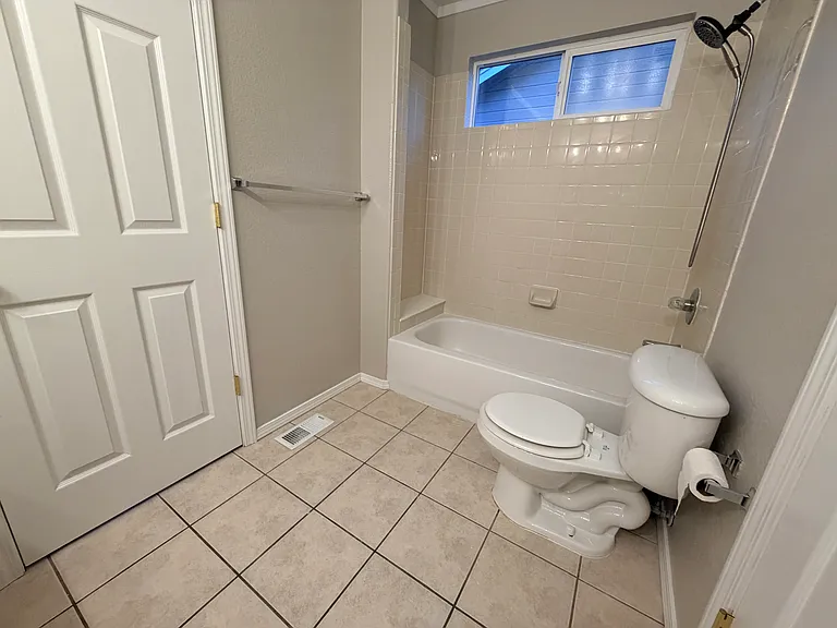 Well-designed Jack-and-Jill bathroom featuring a dual-sink vanity with extended countertop space, separate tub/shower and toilet area, and convenient access from both upstairs bedrooms, providing privacy and functionality for everyday use.